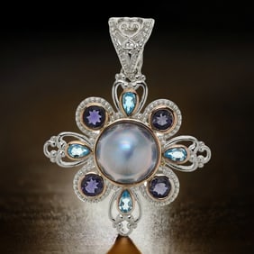 Regal Sterling Silver Mabe Pearl Pendant surrounded by Swiss Blue Topaz & Iolite