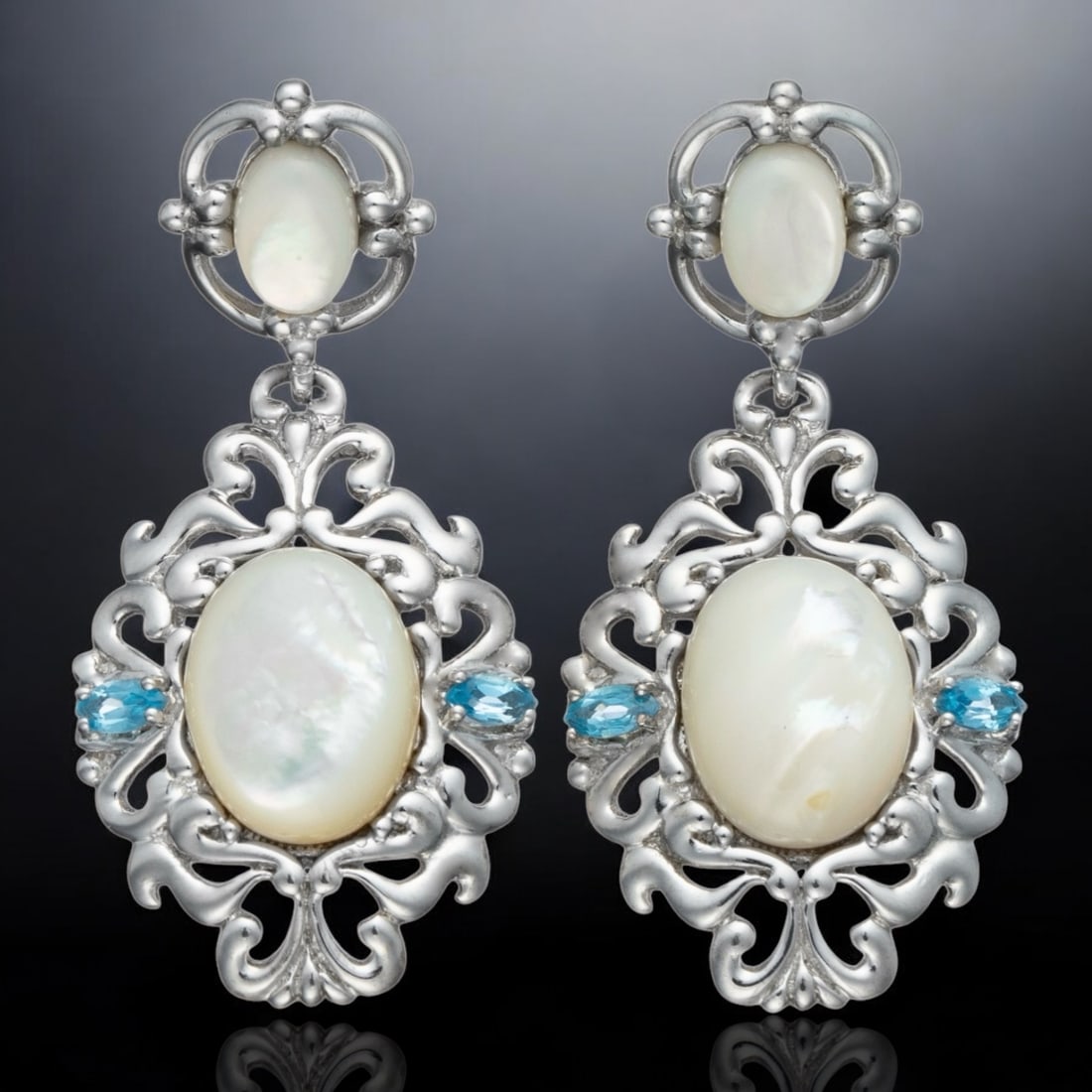 White Mother of Pearl & Blue Topaz Sterling Silver Earrings: Product Details Item: Earrings Metal: Sterling Silver Gemstone: White Mother of Pearl & Blue Topaz Approximate Measurements: 47.5 mm X 22.5 mm Ring Size: Not Applicable Chain Length: Not Applica