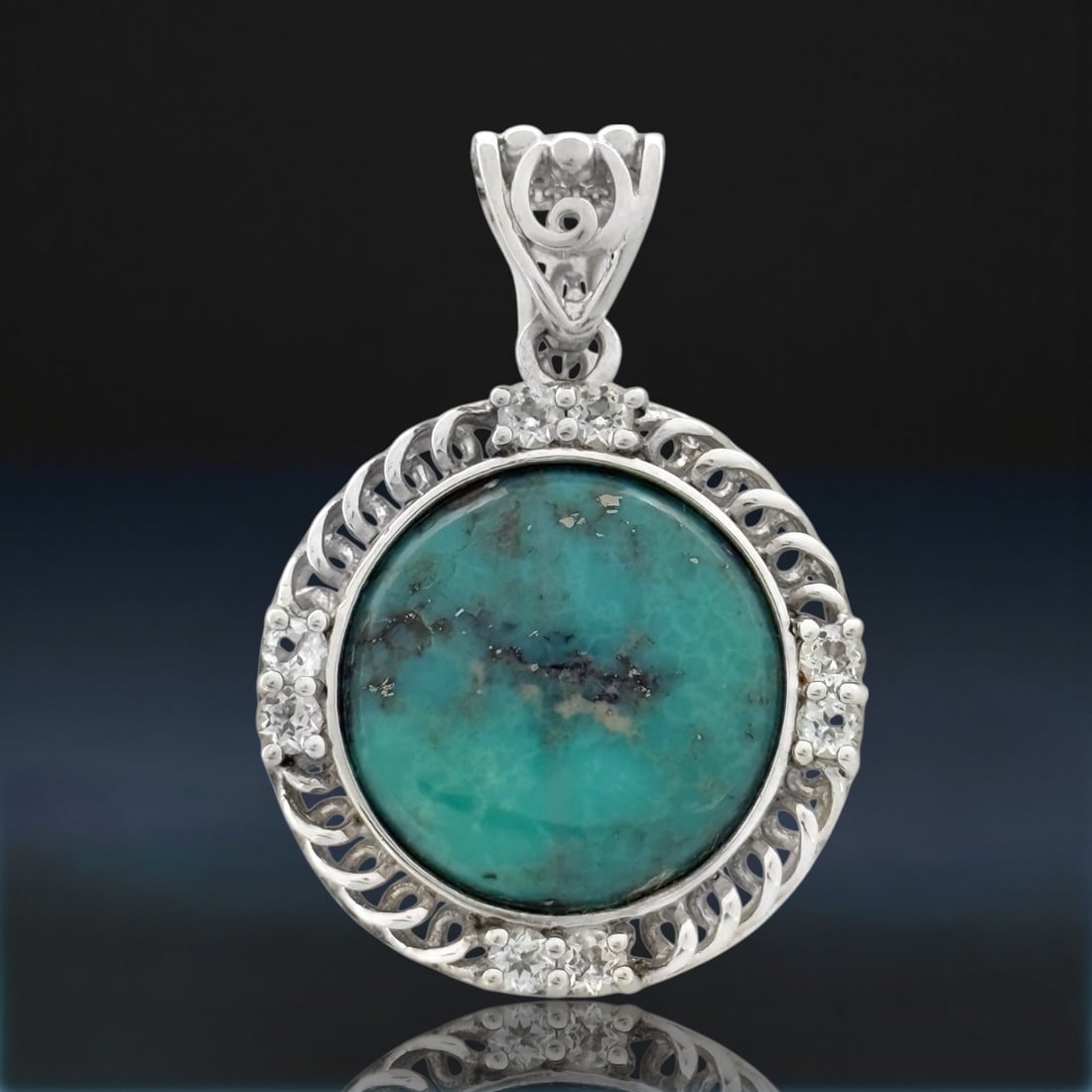 Campo Frio Turquoise & White Topaz Sterling Silver Pendant: Product Details Item: Pendant Metal: Sterling Silver Gemstone: Campo Frio Turquoise & White Topaz Approximate Measurements: 40.7 mm X 28.2 mm Ring Size: Not Applicable Chain Length: Not Applicable<