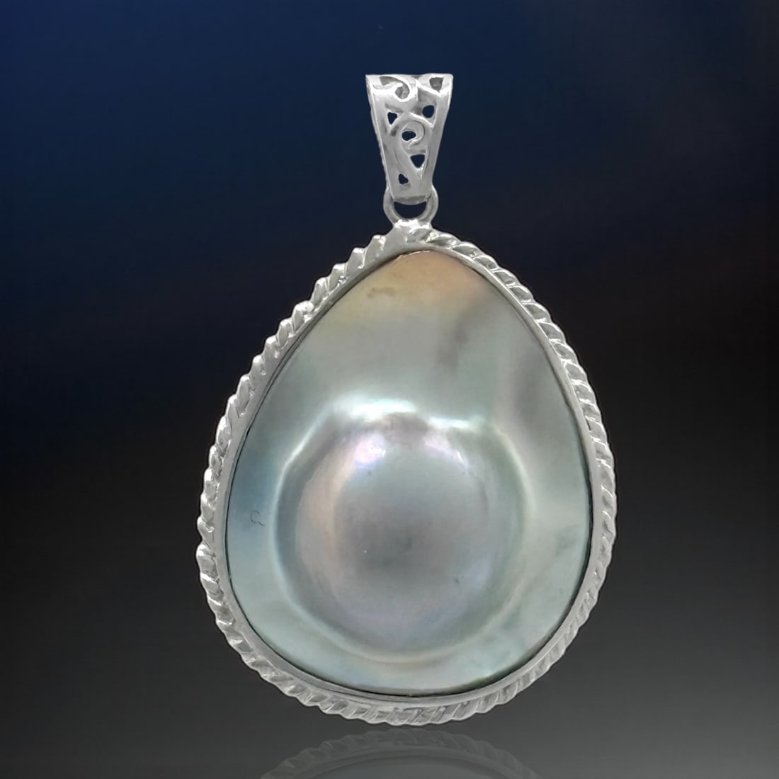 Iridescent Blister Shell Pearl Cable Design Silver Pendant: Product Details Item: Pendant Metal: Sterling Silver Gemstone: Blister Shell Pearl Approximate Measurements: 43 mm X 27.6 mm Ring Size: Not Applicable Chain Length: Not Applicable Chain M