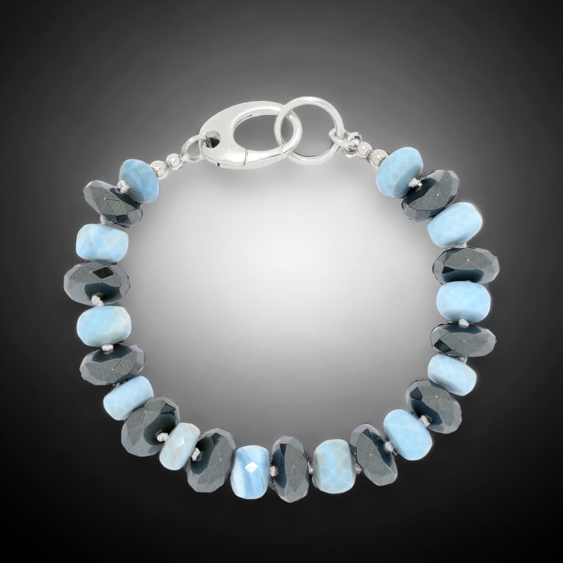 Sparkling Blue Opal & Hematite Sterling Silver Bracelet - 7.75": Blue Opal: 9 mm X 5 mm Hematite Rondelle: 12 mm X 5 mm Product Details Item: Bracelet Metal: Sterling Silver Gemstone: Blue Opal & Hematite Approximate Measurements: Width: 12 mm Ring Size: Not A