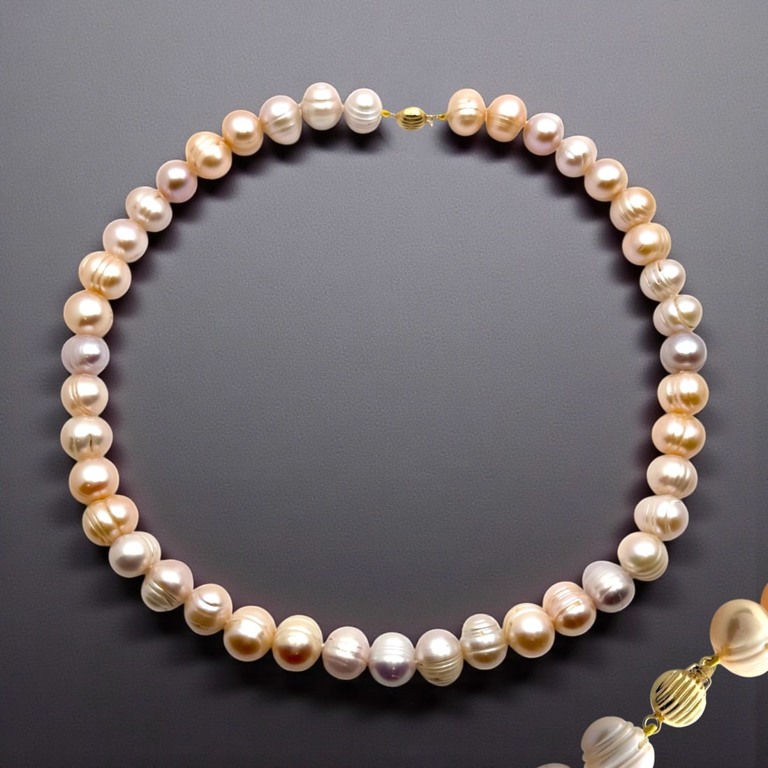 14K Timeless Multicolor Freshwater Pearl Necklace : Product Details Item: Necklace Metal: 14K Gold Gemstone: Multicolor Freshwater Pearl Approximate Measurements: Width: 9-11 mm Ring Size: Not Applicable Chain Length: 17" Chain Metal: Not