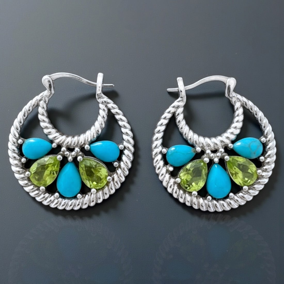 Turquoise Peridot Cable Design Sterling Silver Hoop Earrings: Product Details Item: Earrings Metal: Sterling Silver Gemstone: Turquoise & Peridot Approximate Measurements: 26.7 mm X 24.2 mm Ring Size: Not Applicable Chain Length: Not Applicable Chain