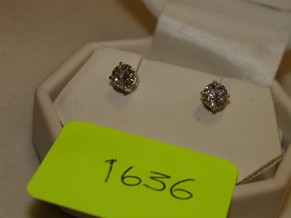 Plated White Gold Diamond Stud Screw-Back Earring: Stamped 14K Four-Claw set with:One Round Brilliant Cut Diamond, Measuring Approx. 5.29 x 5.30 x 3.30mm Weight 0.564 ct. Colour:L E Clarity: SI2 Cut: Good - Very GoodNote: This Diamond was Previously A