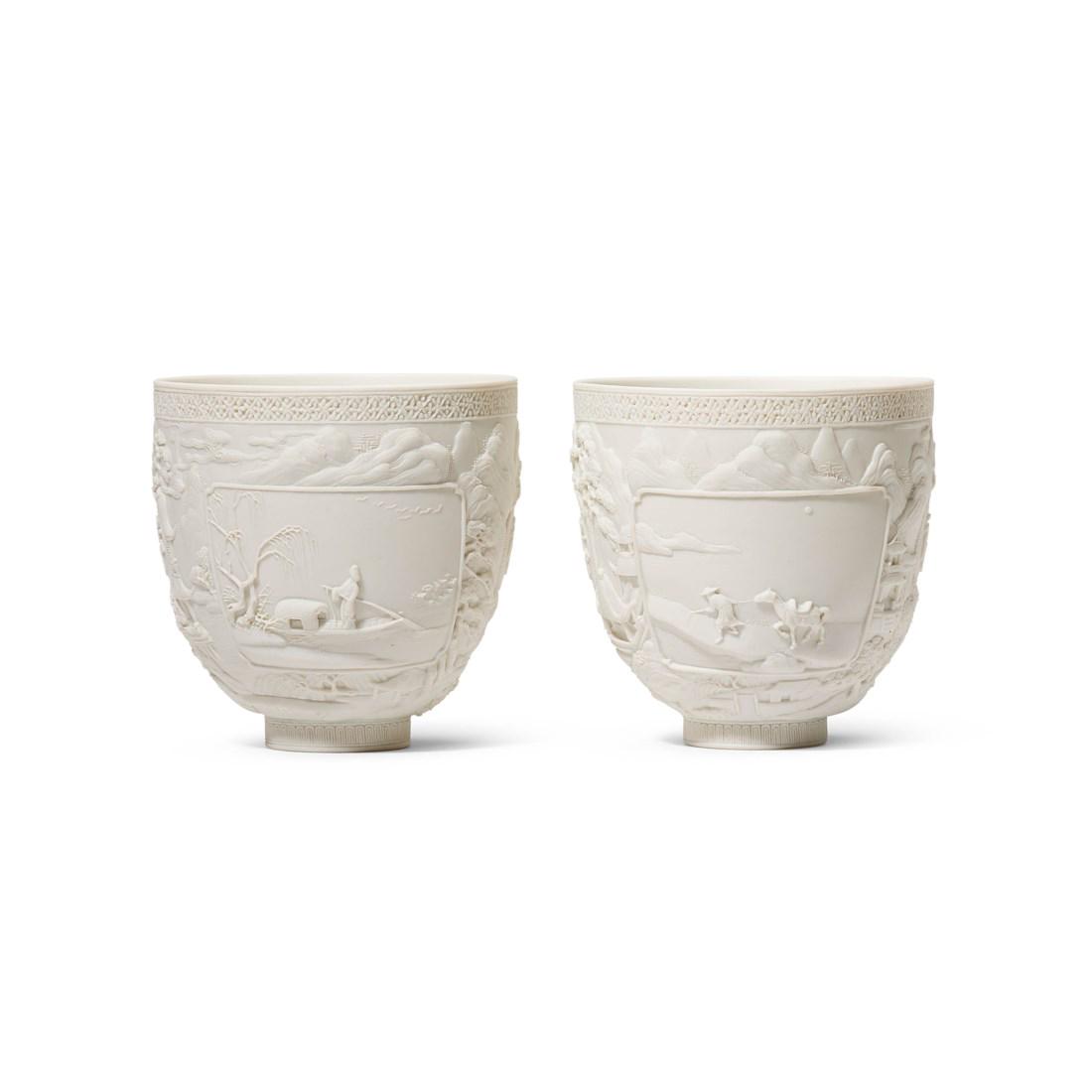 A PAIR OF CARVED BISCUIT PORCELAIN ’LANDSCAPE' CUPS