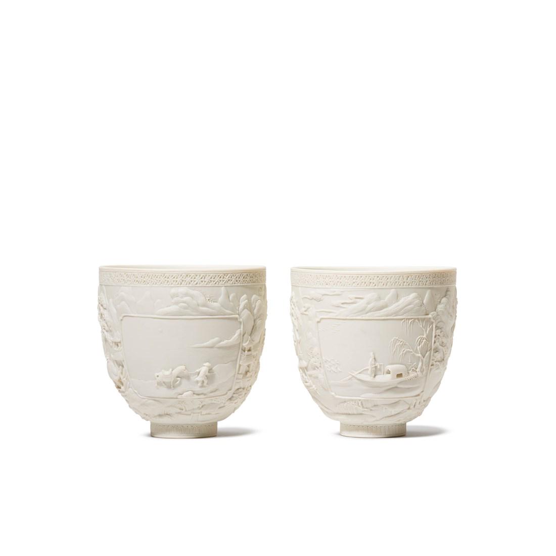 A PAIR OF CARVED BISCUIT PORCELAIN ’LANDSCAPE' CUPS