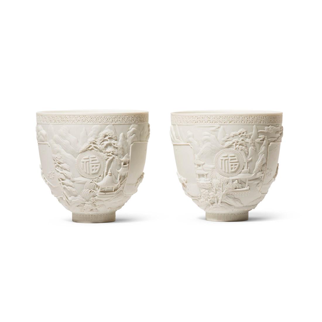 A PAIR OF CARVED BISCUIT PORCELAIN ’LANDSCAPE' CUPS