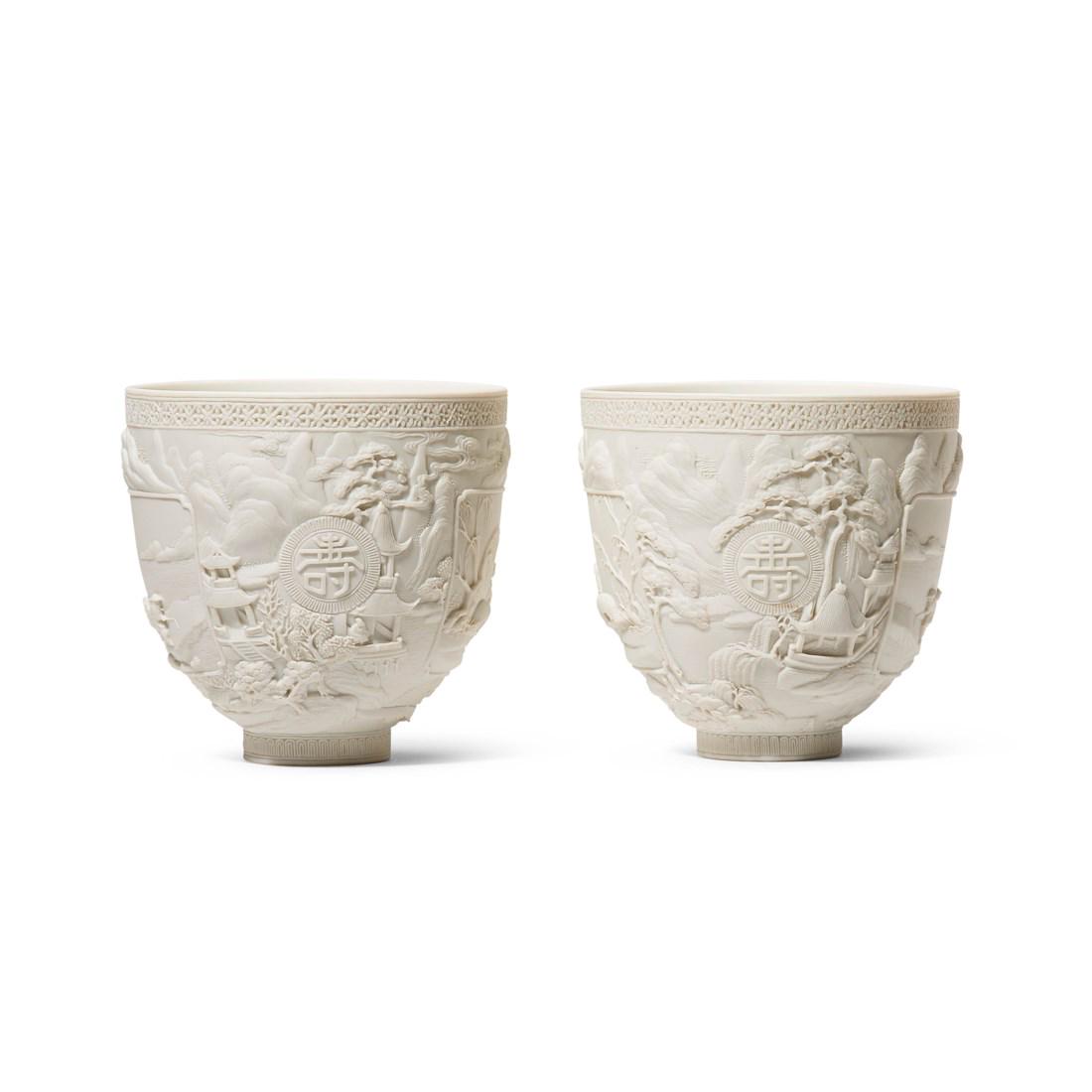 A PAIR OF CARVED BISCUIT PORCELAIN ’LANDSCAPE' CUPS