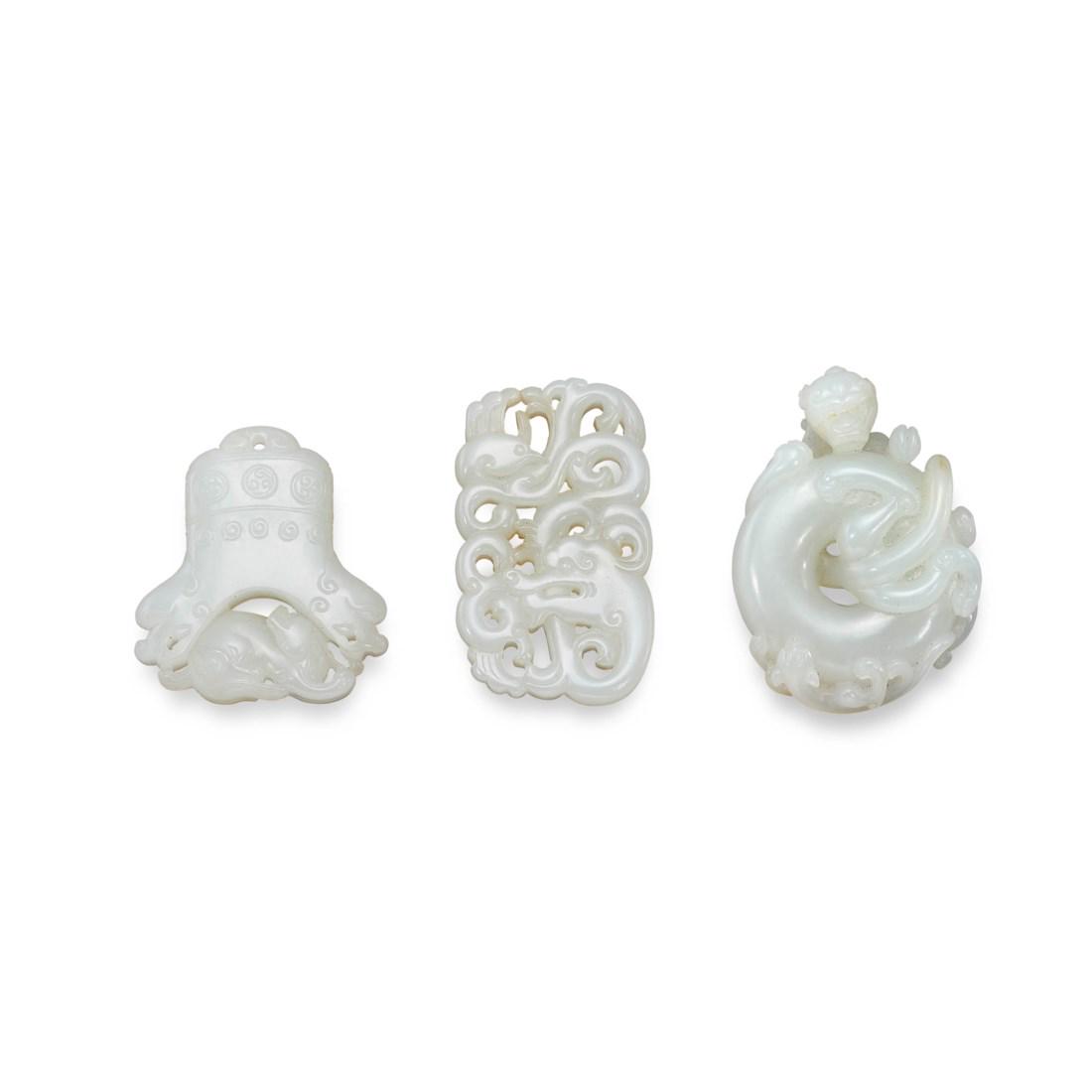 THREE CARVED WHITE JADE OPENWORK ‘DRAGON’ PENDANTS