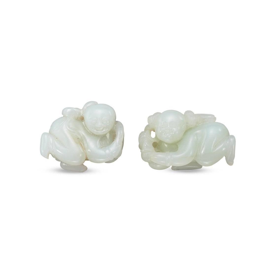 TWO CARVED WHITE JADE ‘BOY’ TOGGLES