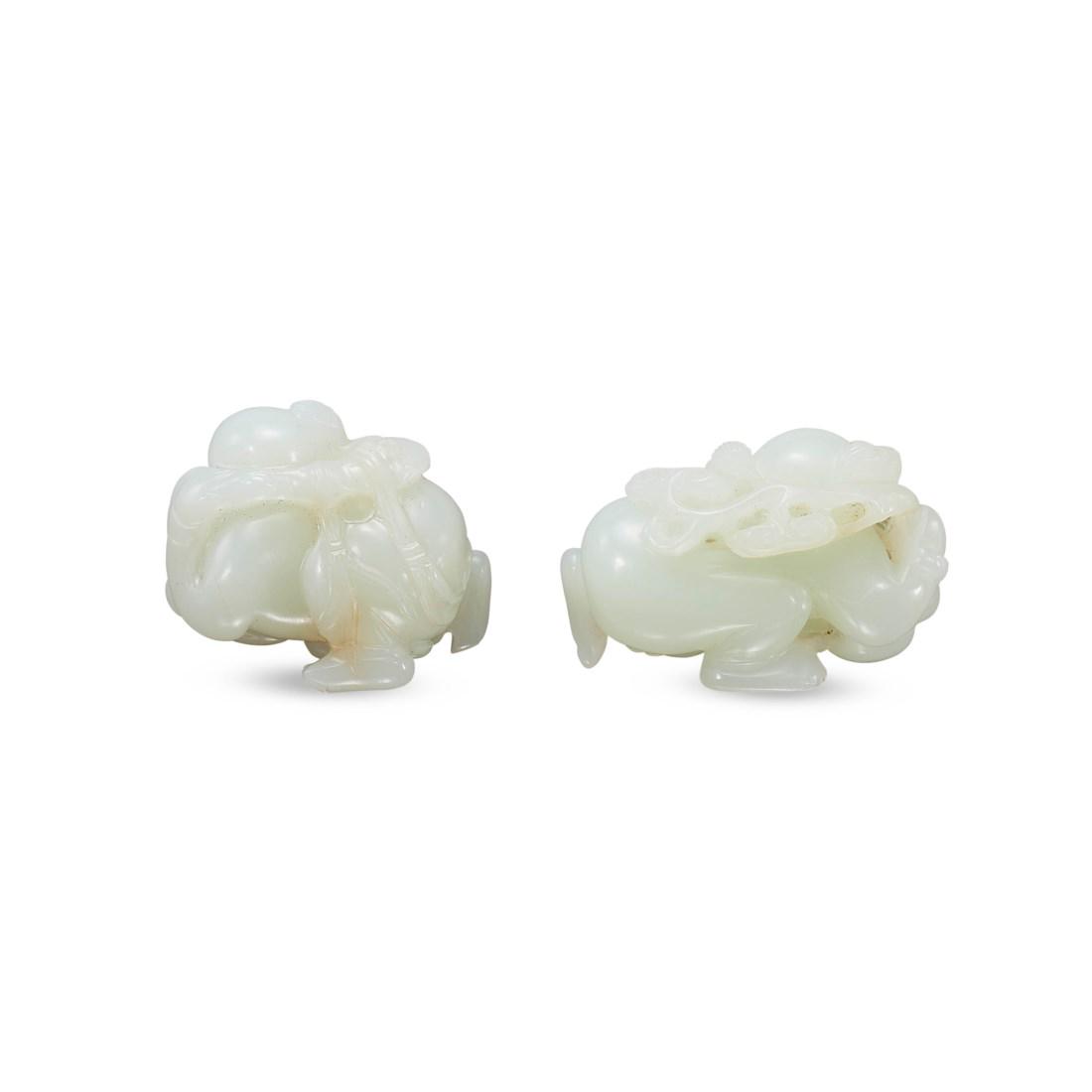 TWO CARVED WHITE JADE ‘BOY’ TOGGLES