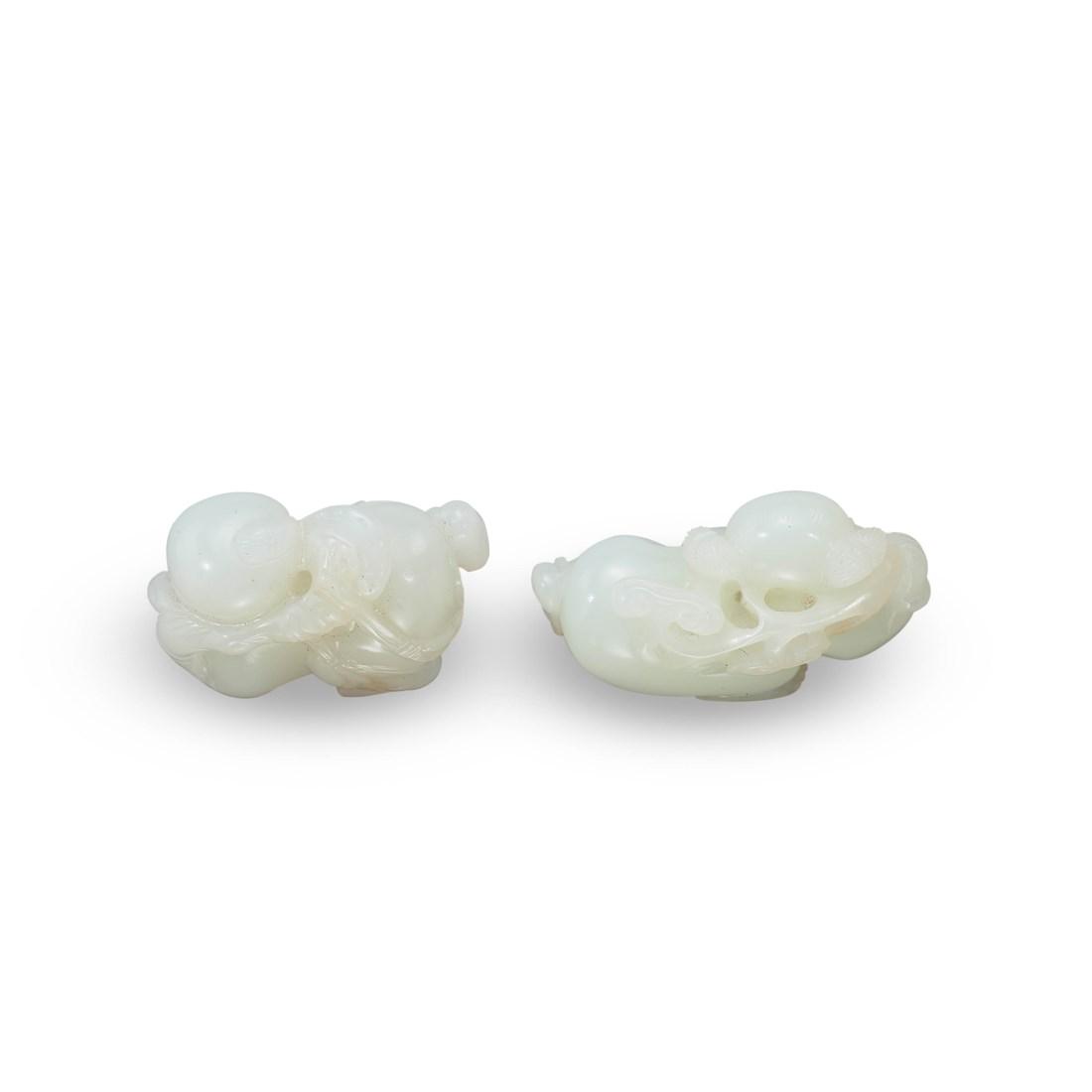 TWO CARVED WHITE JADE ‘BOY’ TOGGLES