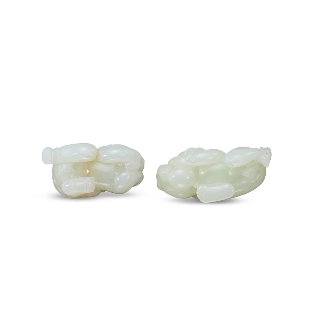 TWO CARVED WHITE JADE ‘BOY’ TOGGLES