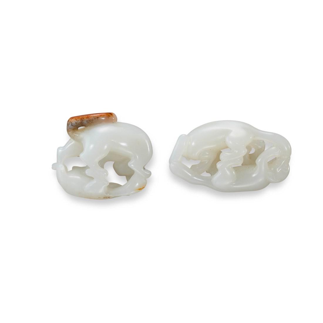 TWO CARVED WHITE JADE ‘TWIN-BADGER’ TOGGLES