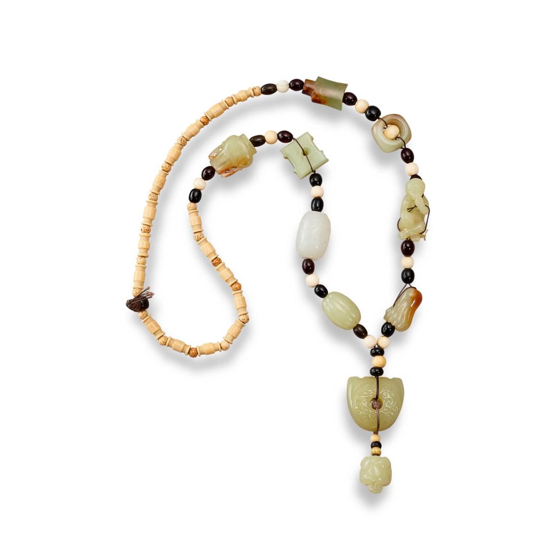 A YELLOW AND WHITE JADE AND BONE NECKLACE