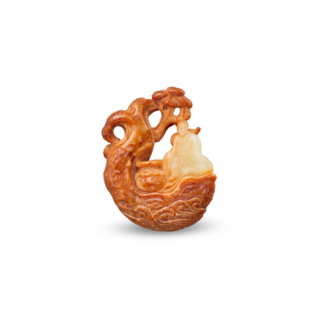 A YELLOW AND RUSSET JADE 'ZHANG QIAN' CARVING