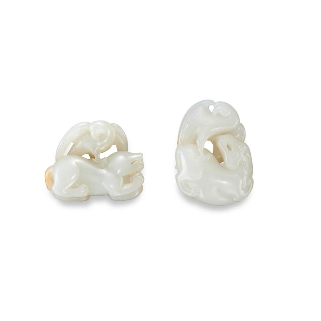 TWO CARVED WHITE JADE ‘EAGLE AND BEAR’ TOGGLES