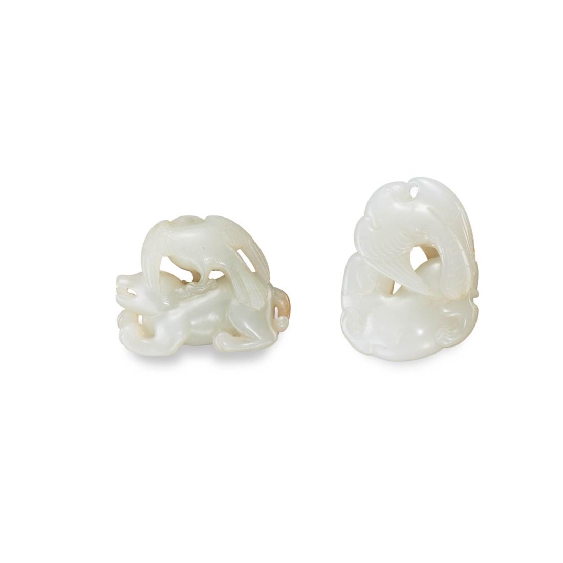 TWO CARVED WHITE JADE ‘EAGLE AND BEAR’ TOGGLES