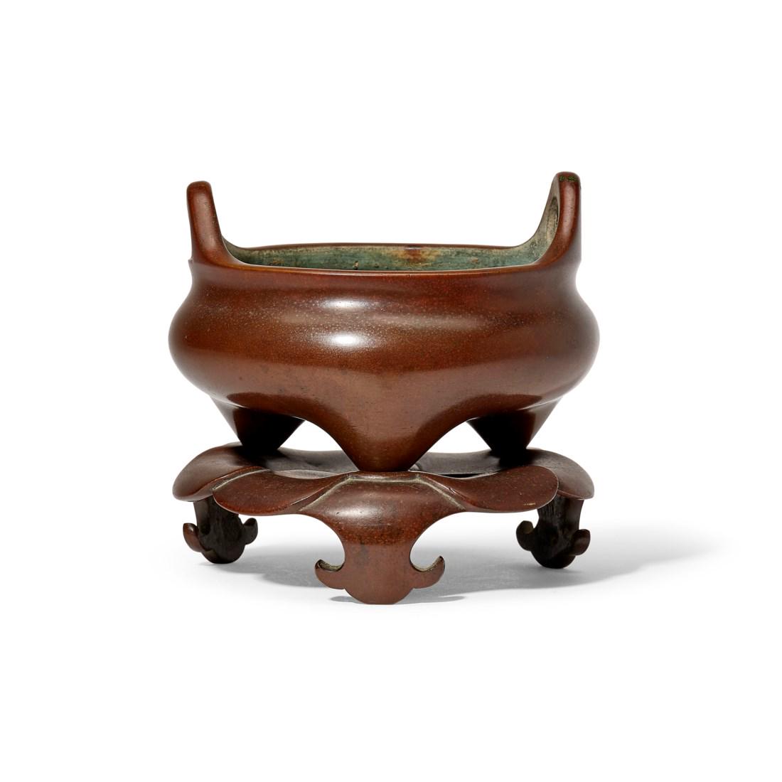 A BRONZE TRIPOD CENSER AND STAND