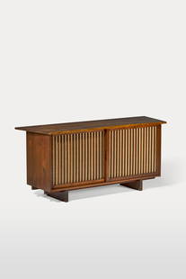 GEORGE NAKASHIMA (1905-1990): SLIDING DOOR CABINET, 1966 GEORGE NAKASHIMA (1905-1990) Sliding Door Cabinet, 1966 American black walnut, pandanus cloth 31 ¾ x 71 ¼ x 22 ¼ in. (80.7 x 181 x 56.5 cm) inscribed with ori