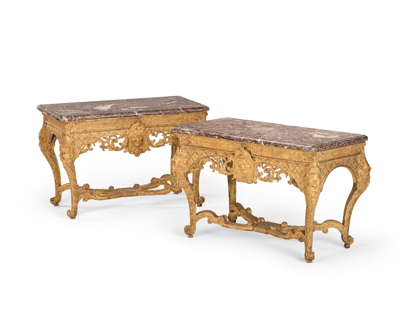 A PAIR OF FRENCH GILTWOOD CONSOLE TABLES: A PAIR OF FRENCH GILTWOOD CONSOLE TABLES 20TH CENTURY, POSSIBLY INCORPORATING EARLIER ELEMENTS, MINOR DIFFERENCES IN DIMENSIONS AND CARVING Details In the Régence style, each with a rounded recta