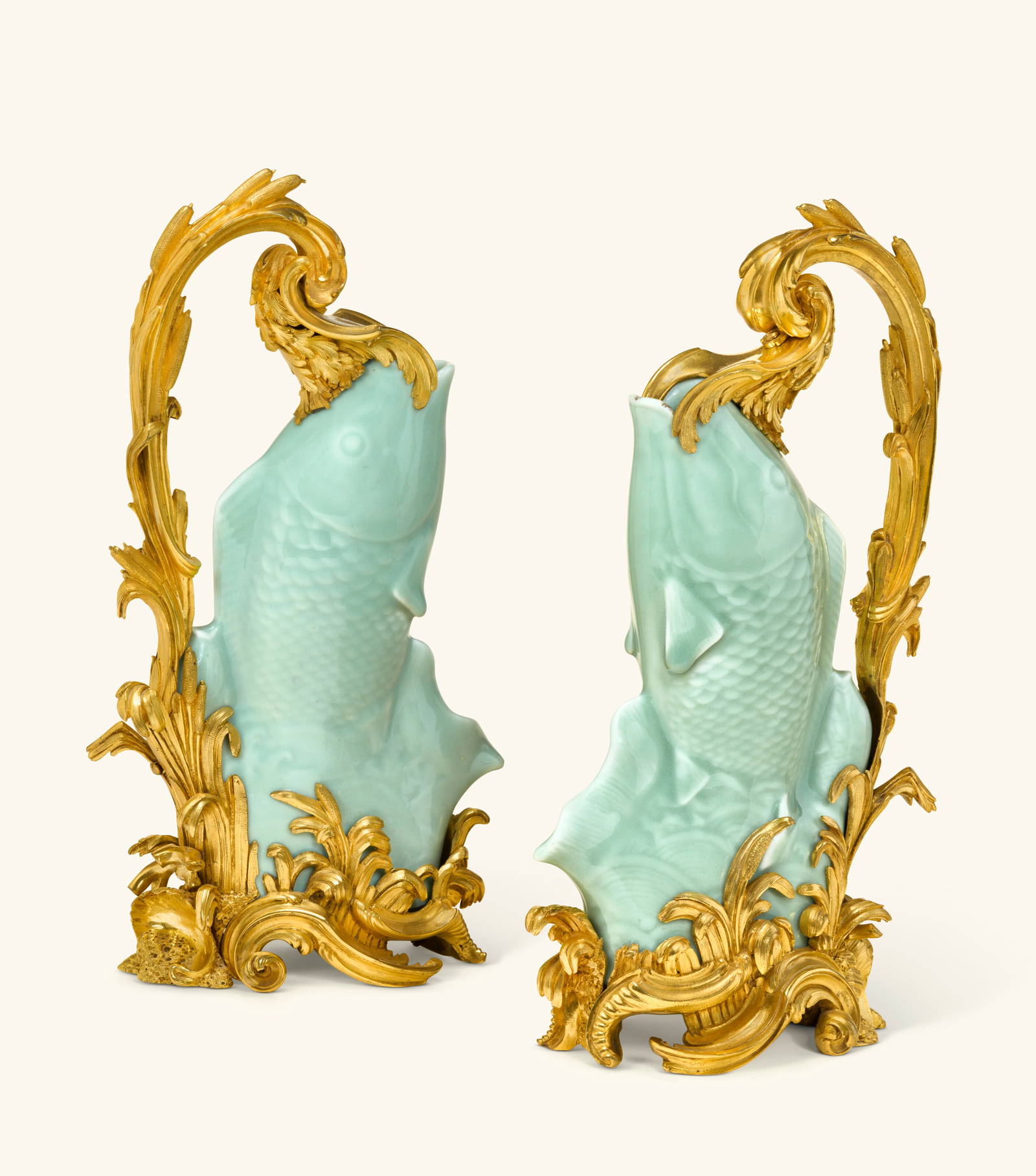 A PAIR OF LOUIS XV ORMOLU-MOUNTED CHINESE CELADON PORCELAIN EWERS ALMOST CERTAINLY SUPPLIED BY