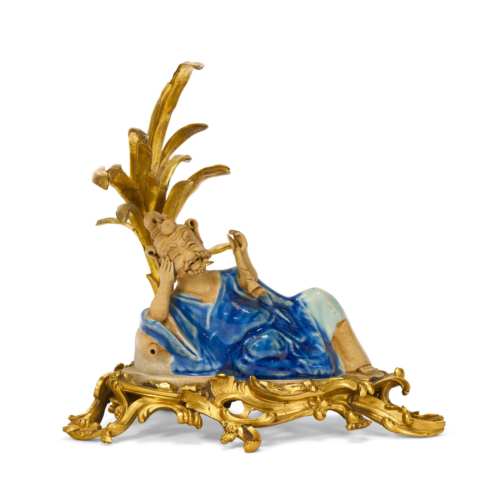 A LOUIS XV ORMOLU-MOUNTED CHINESE EXPORT BLUE-GLAZED AND BISCUIT PORCELAIN FIGURE OF A LUOHAN THE