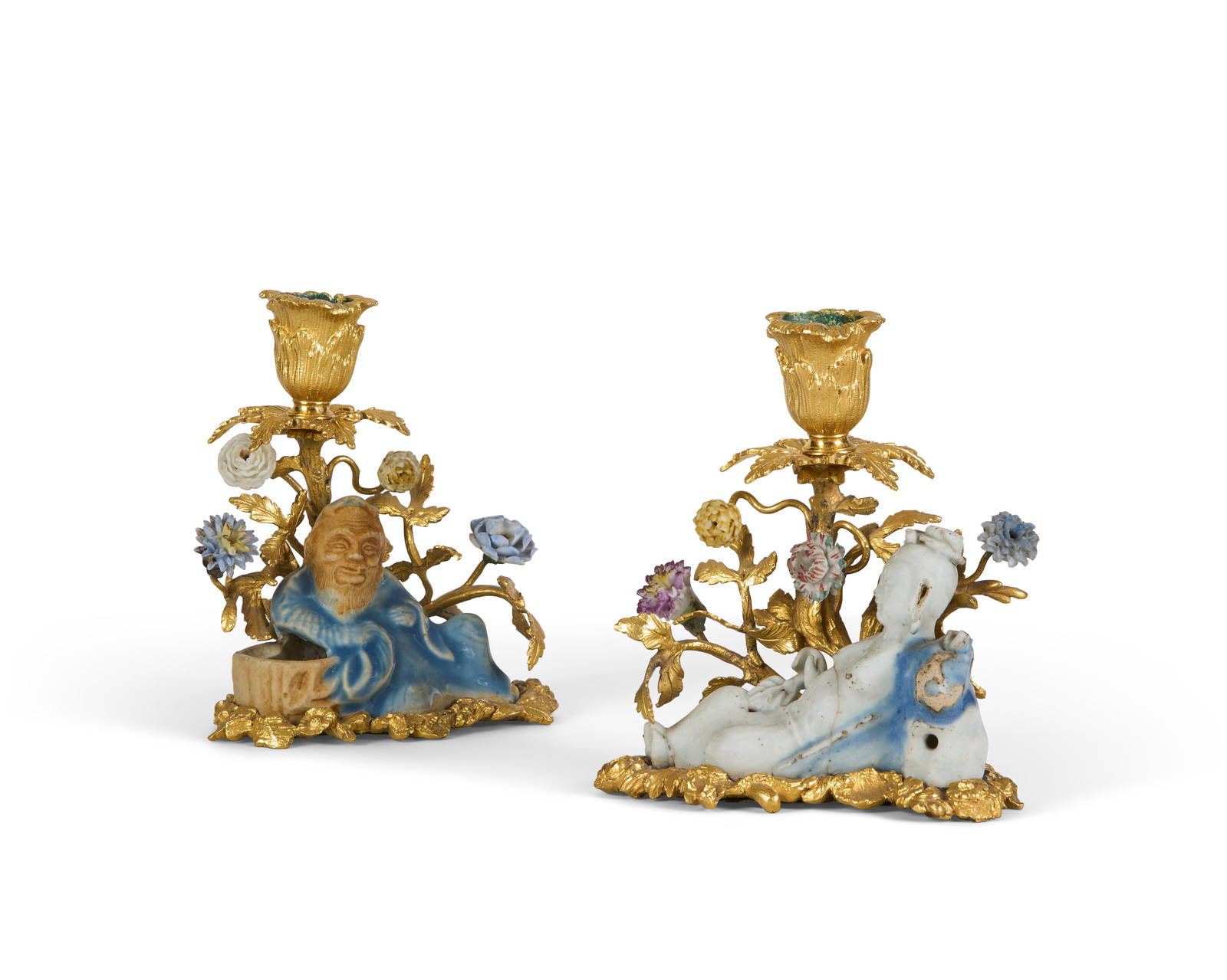 A PAIR OF LOUIS XV ORMOLU-MOUNTED CHINESE BLUE-GLAZED PORCELAIN CANDLESTICKS THE PORCELAIN KANGXI
