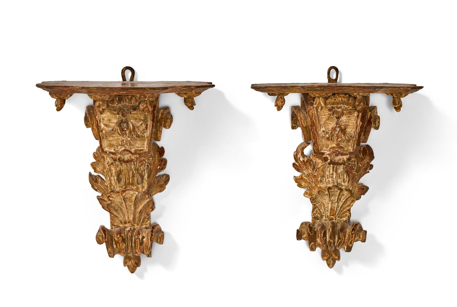 A NEAR PAIR OF REGENCE GILTWOOD BRACKETS CIRCA 1725, ONE POSSIBLY OF A LATER DATE: A NEAR PAIR OF REGENCE GILTWOOD BRACKETS CIRCA 1725, ONE POSSIBLY OF A LATER DATE Details A NEAR PAIR OF REGENCE GILTWOOD BRACKETS CIRCA 1725, ONE POSSIBLY OF A LATER DATE Each with a shaped top on a