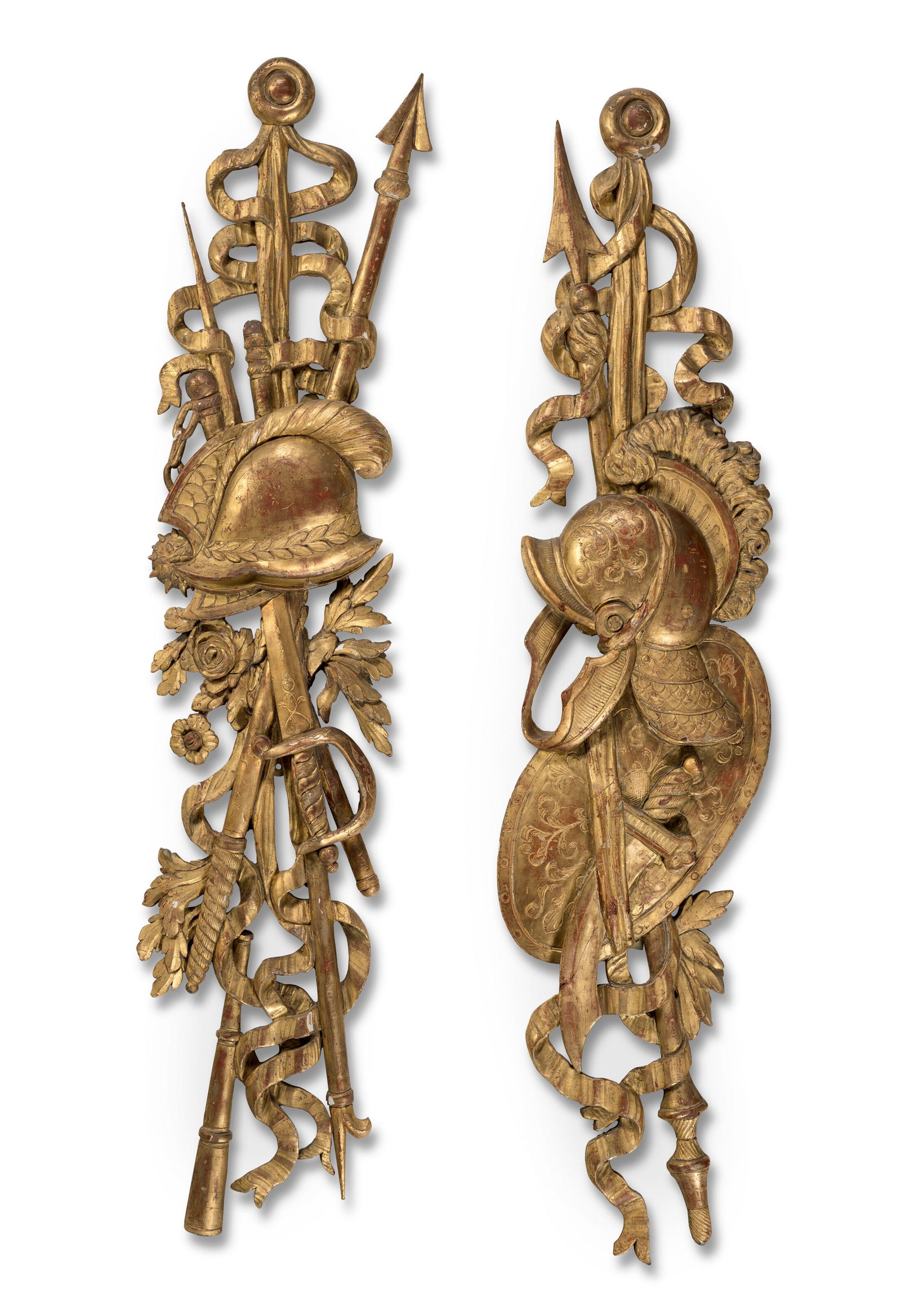 A PAIR OF ITALIAN GILTWOOD WALL-TROPHIES 19TH/20TH CENTURY: A PAIR OF ITALIAN GILTWOOD WALL-TROPHIES 19TH/20TH CENTURY Details A PAIR OF ITALIAN GILTWOOD WALL-TROPHIES 19TH/20TH CENTURY Each carved with a helmet and military trophies entwined with ribbons and