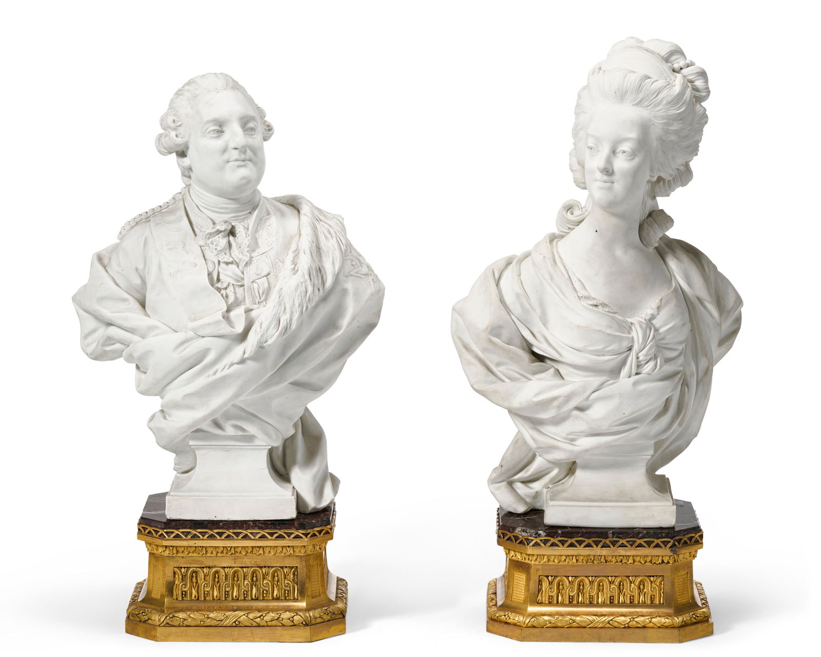 A PAIR OF SEVRES HARD PASTE BISCUIT PORCELAIN PORTRAIT BUSTS OF KING LOUIS XVI AND QUEEN: A PAIR OF SEVRES HARD PASTE BISCUIT PORCELAIN PORTRAIT BUSTS OF KING LOUIS XVI AND QUEEN MARIE-ANTOINETTE OF FRANCE CIRCA 1785-1788, INCISED MARKS ALONG THE EDGES OF THE SOCLES, THE BASES LOUIS XVI,