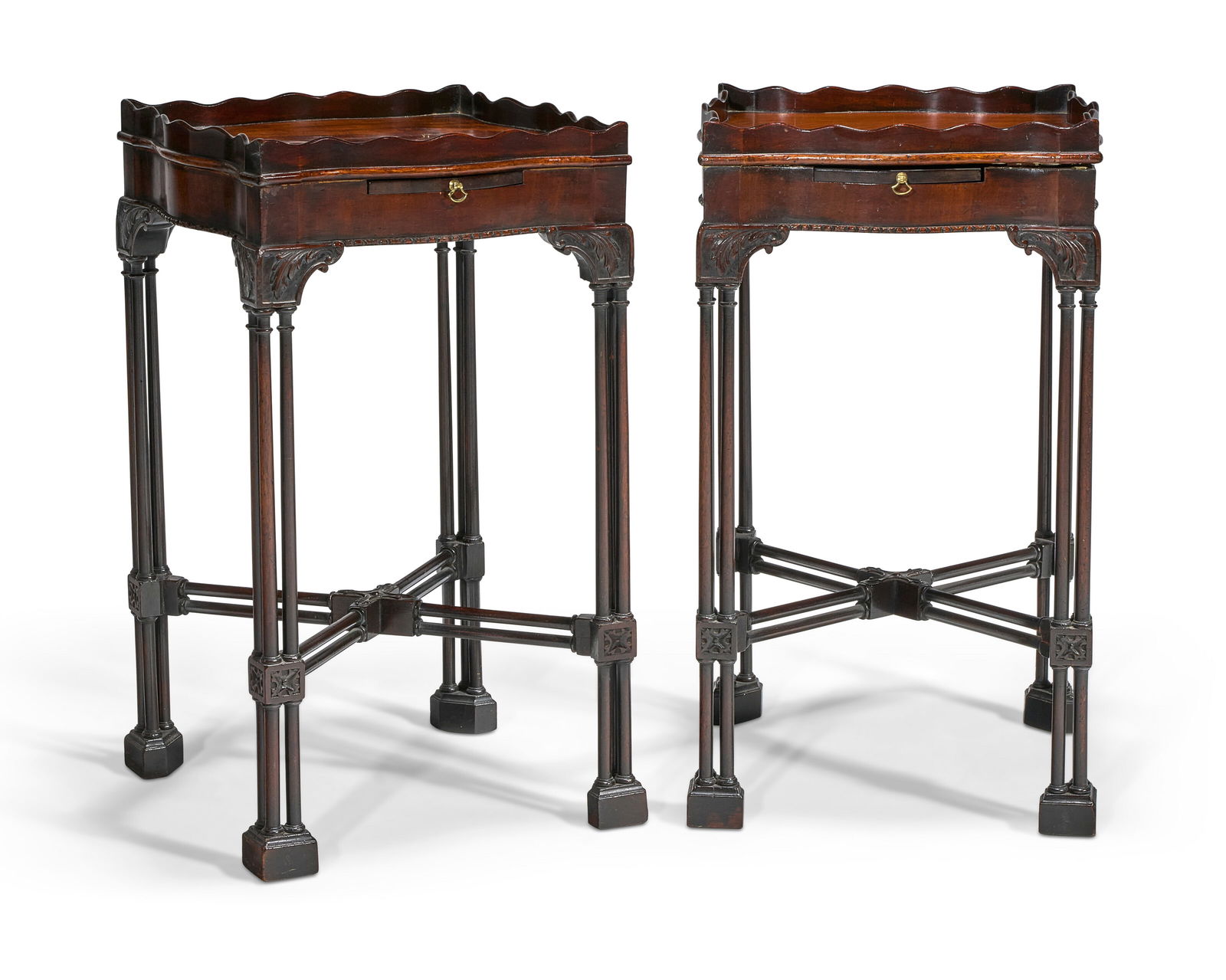 A PAIR OF ENGLISH MAHOGANY KETTLE STANDS EARLY 20TH CENTURY: A PAIR OF ENGLISH MAHOGANY KETTLE STANDS EARLY 20TH CENTURY Details Each square top with waved gallery and candleslide, on cluster-column legs joined by an X-form stretcher 213⁄4 in. (55.2 cm.)