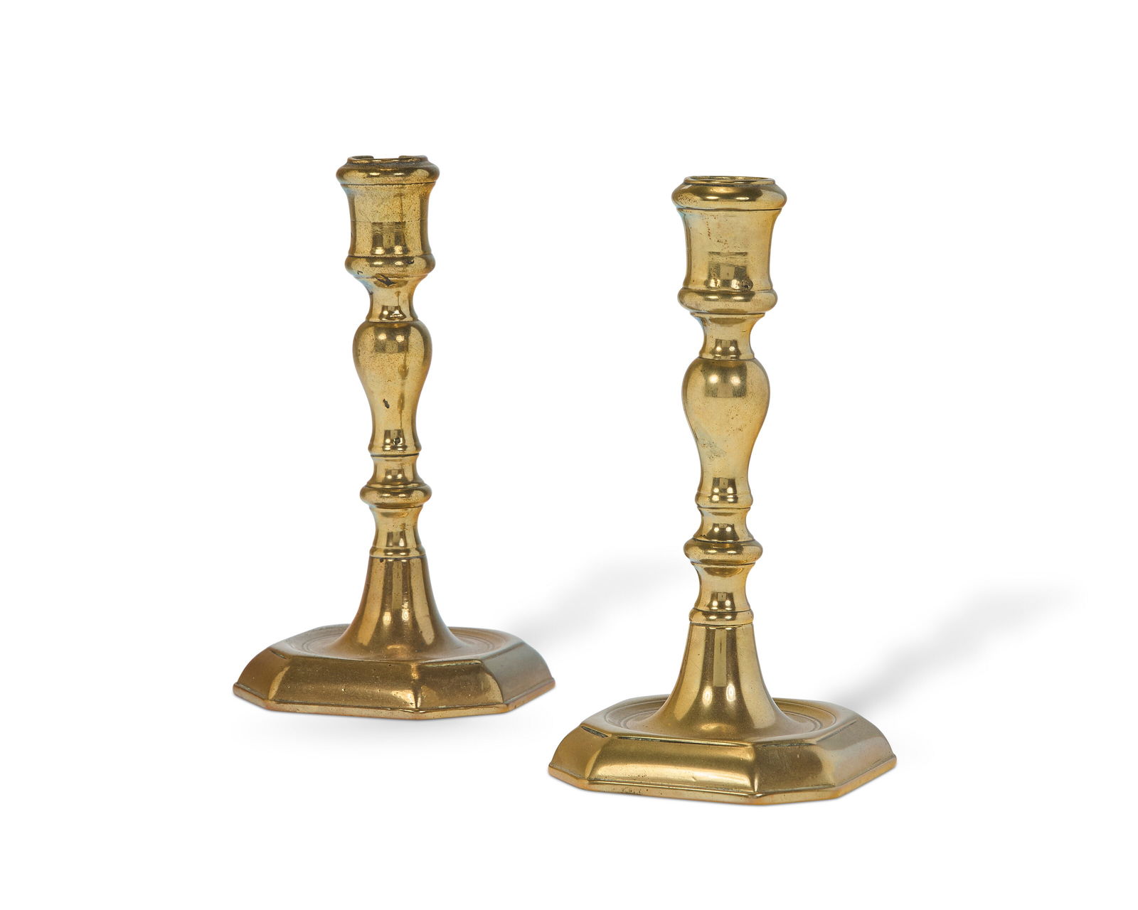 A PAIR OF GEORGE II BRASS CANDLESTICKS CIRCA 1740 (1 of 2)