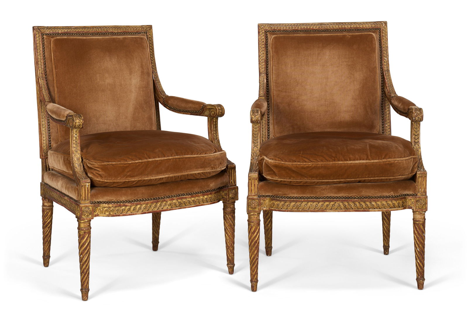 A PAIR OF FRENCH GILTWOOD FAUTEUILS LATE 19TH CENTURY: A PAIR OF FRENCH GILTWOOD FAUTEUILS LATE 19TH CENTURY Details Each rectangular back carved with guilloché, the scrolling arms carved with piastres and continuing to spirally-fluted legs, covered