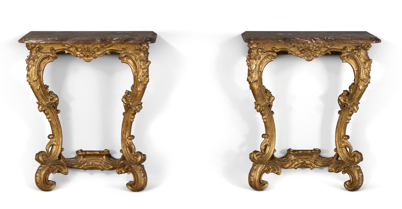 A PAIR OF GERMAN GILTWOOD CONSOLE TABLES PROBABLY MID-18TH CENTURY: A PAIR OF GERMAN GILTWOOD CONSOLE TABLES PROBABLY MID-18TH CENTURY Details With later rounded rectangular marble tops, the friezes carved with rocaille and acanthus, the pierced cabriole legs carved a
