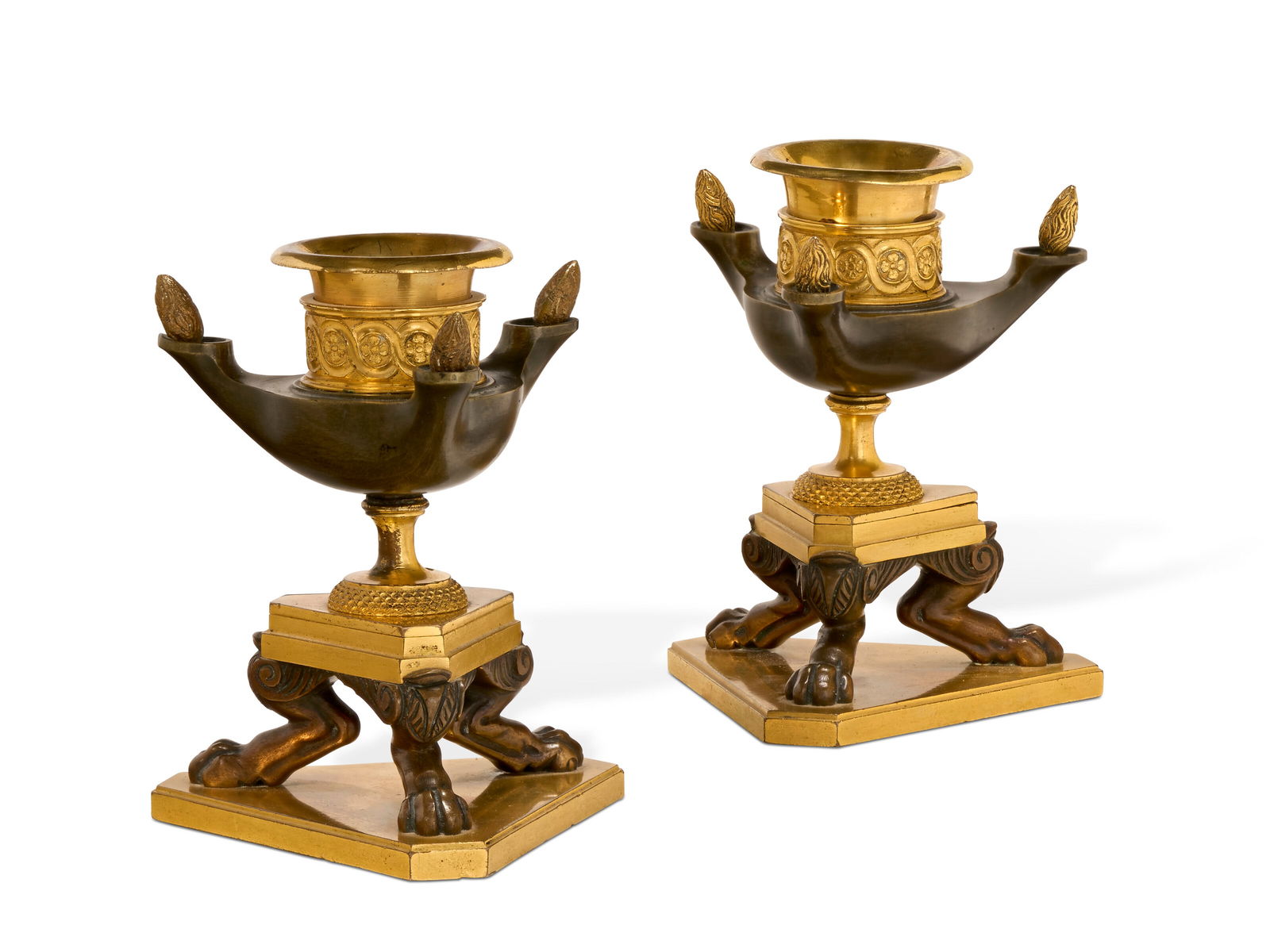 A PAIR OF RESTAURATION ORMOLU AND PATINATED BRONZE CANDLESTICKS POSSIBLY NORTH EUROPEAN, CIRCA (1 of 2)