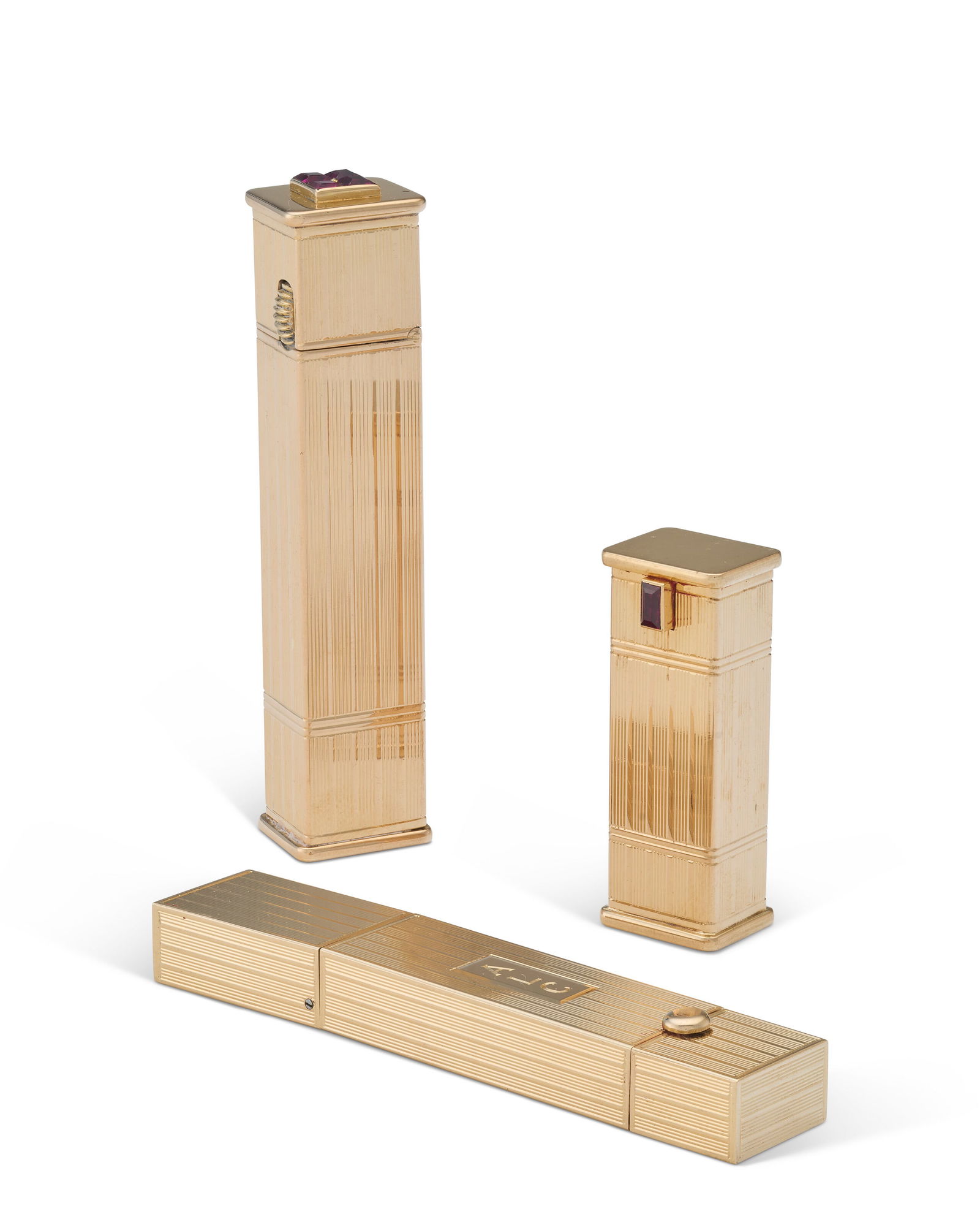A JEWELED GOLD LIPSTICK HOLDER WITH CONCEALED WATCH, AND SIMILAR JEWELED GOLD LIPSTICK HOLDER AND: A JEWELED GOLD LIPSTICK HOLDER WITH CONCEALED WATCH, AND SIMILAR JEWELED GOLD LIPSTICK HOLDER AND LIGHTER VARIOUS MAKERS INCLUDING CARTIER, CIRCA 1935 Details The lipstick holder and watch rectangular