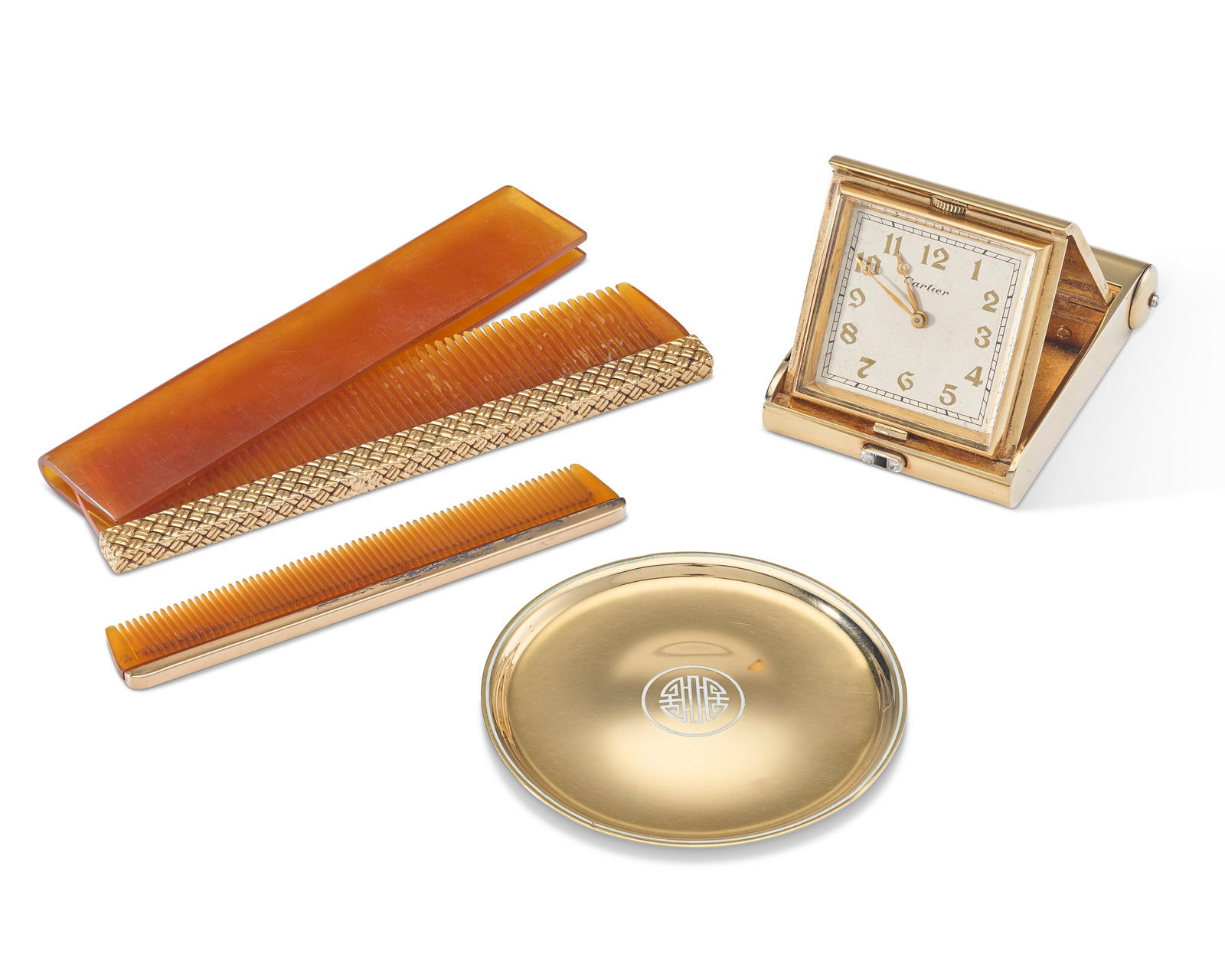 AN AMERICAN GOLD TRAVEL CLOCK AND PIN TRAY MARK OF CARTIER, NEW YORK, FIRST HALF 20TH CENTURY: AN AMERICAN GOLD TRAVEL CLOCK AND PIN TRAY MARK OF CARTIER, NEW YORK, FIRST HALF 20TH CENTURY Details The travel clock rounded rectangular, the cover engraved with monogram ACL within a ring of diamon