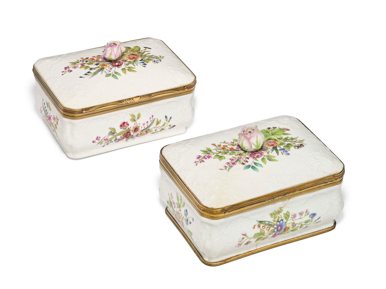 TWO GILT-METAL MOUNTED GERMAN PORCELAIN TOBACCO BOXES AND COVERS 19TH CENTURY: TWO GILT-METAL MOUNTED GERMAN PORCELAIN TOBACCO BOXES AND COVERS 19TH CENTURY Details In the Meissen style, each box surmounted by a rose finial and molded with basketweave within scrollwork rims, fur