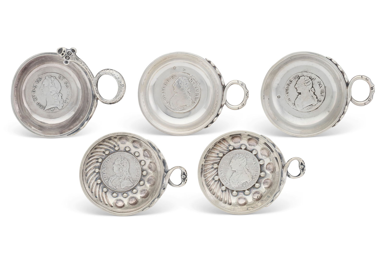 A GROUP OF FIVE FRENCH SILVER WINE TASTERS PARIS, EARLY 20TH CENTURY, TWO MARK OF VAGUER AND TWO: A GROUP OF FIVE FRENCH SILVER WINE TASTERS PARIS, EARLY 20TH CENTURY, TWO MARK OF VAGUER AND TWO POSSIBLY MARK OF EDMOND ECKARD Details Circular with loop handles formed as intertwined serpents, one w