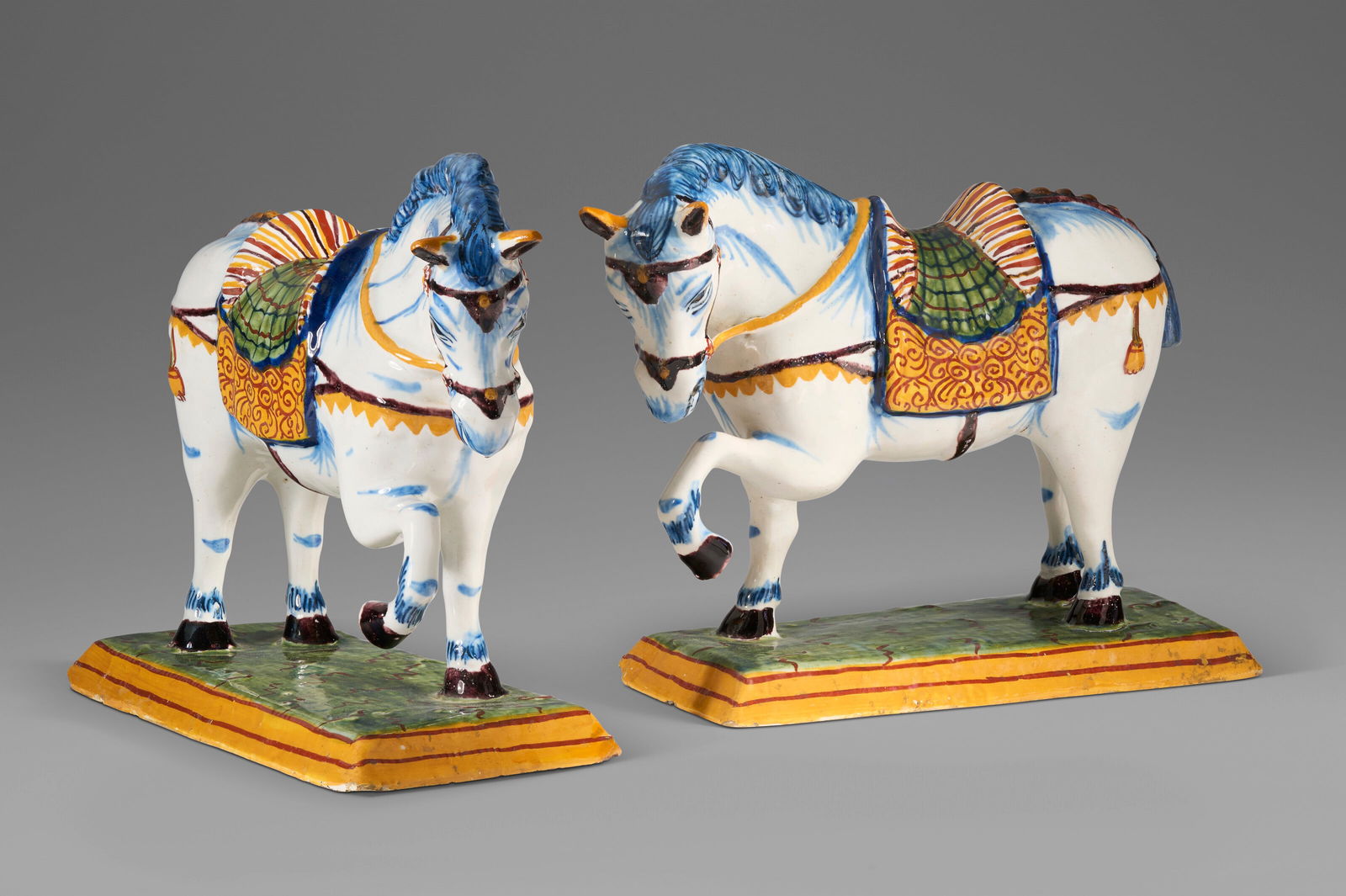 A PAIR OF DUTCH DELFT POLYCHROME MODELS OF PRANCING HORSES CIRCA 1760, IRON-RED P:V:M MARK TO EACH, (1 of 5)