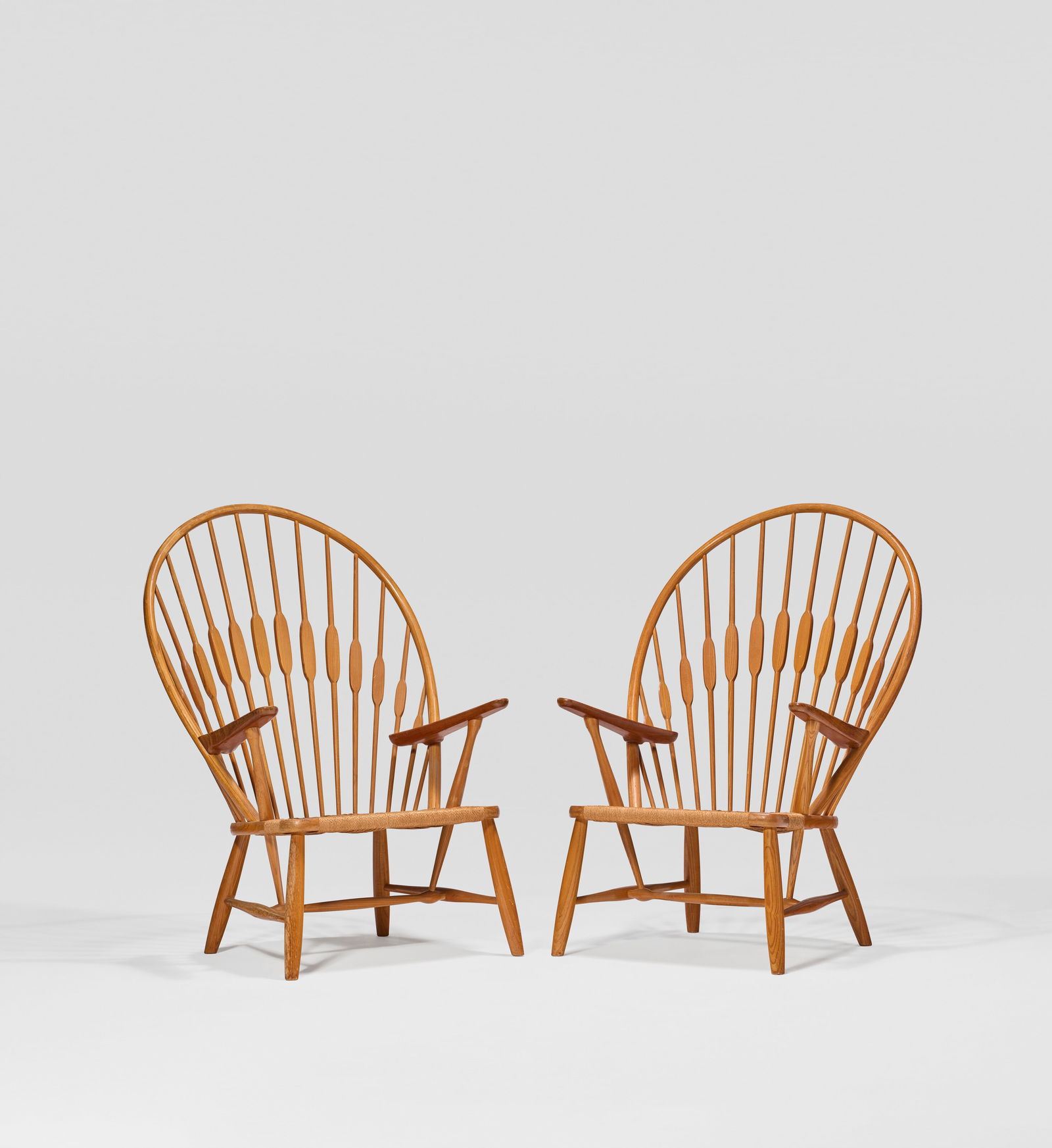 HANS J. WEGNER (1914-2007) Pair of 'Peacock' Chairs, Model No. JH550, designed 1947, executed circa: HANS J. WEGNER (1914-2007) Pair of 'Peacock' Chairs, Model No. JH550, designed 1947, executed circa 1965 Details manufactured by Johannes Hansen, Copenhagen, Denmark teak, grass cord 421⁄2 x 301