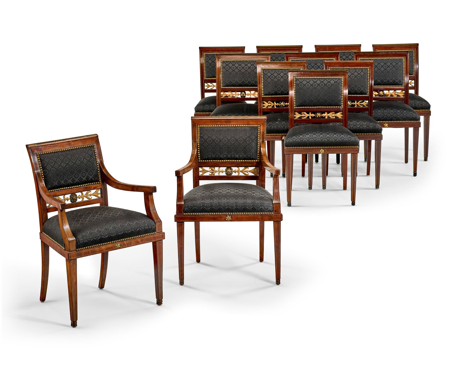 A SET OF TWELVE NORTH EUROPEAN BRASS-INLAID AND MOUNTED PARCEL-GILT MAHOGANY DINING CHAIRS 19TH: A SET OF TWELVE NORTH EUROPEAN BRASS-INLAID AND MOUNTED PARCEL-GILT MAHOGANY DINING CHAIRS 19TH CENTURY, THE FOUR LARGER SIDE CHAIRS OF LATER DATE Details Comprising two armchairs and ten side chairs