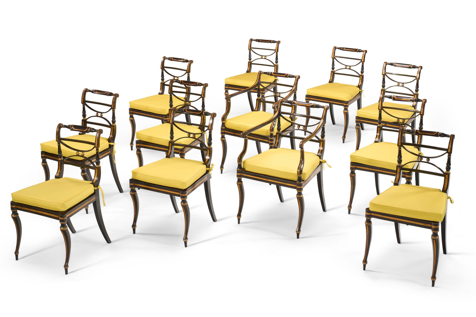 A SET OF TWELVE REGENCY EBONIZED AND PARCEL-GILT DINING CHAIRS CIRCA 1815, MINOR VARIATIONS: A SET OF TWELVE REGENCY EBONIZED AND PARCEL-GILT DINING CHAIRS CIRCA 1815, MINOR VARIATIONS Details Comprising ten side chairs and two armchairs; some stamped 'M', some inscribed '7660' in yellow chal