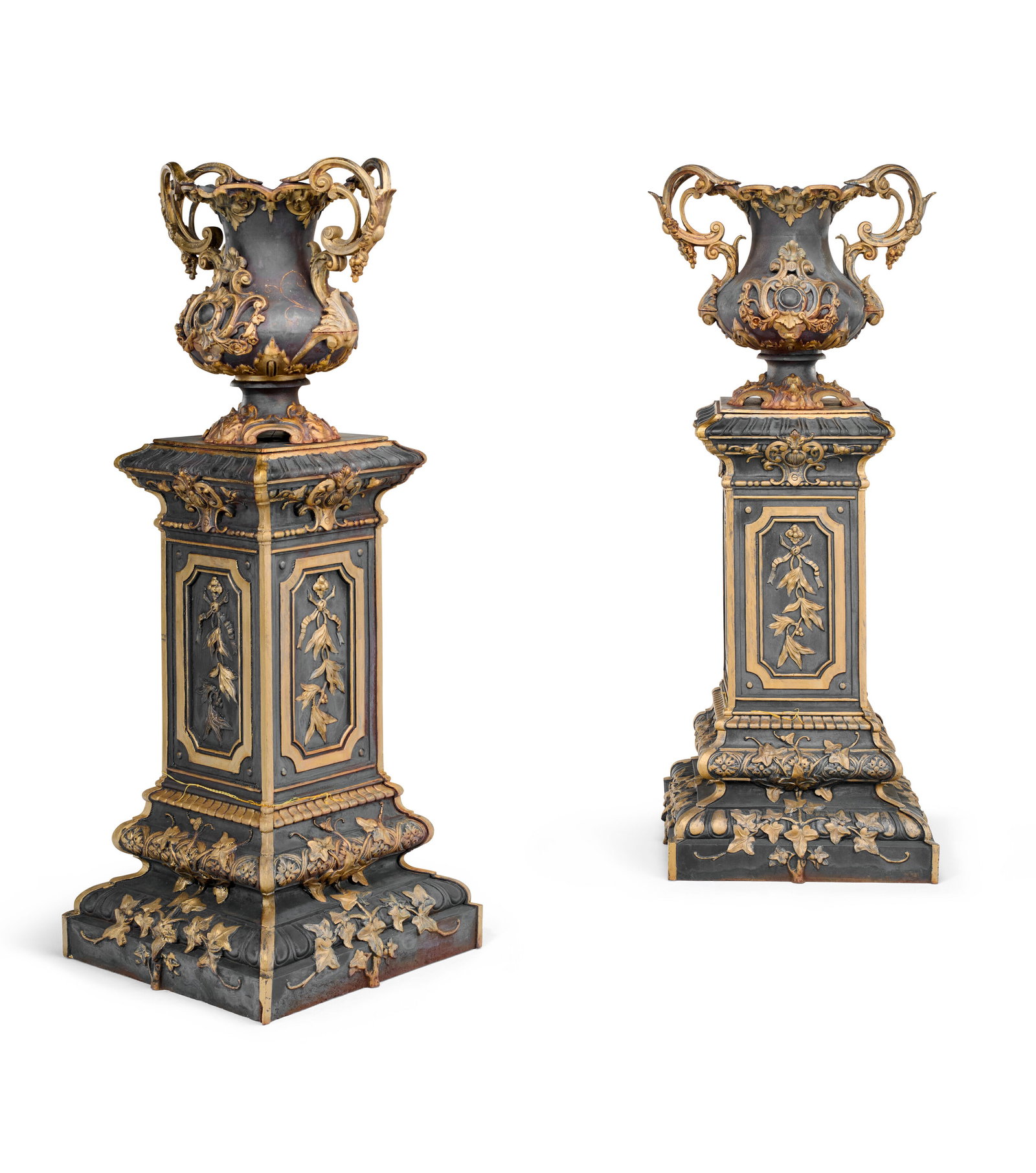 A PAIR OF FRENCH PARCEL-GILT AND BLACK-PAINTED CAST-IRON VASES, ON PEDESTALS CAST BY ALFRED CORNEAU, (1 of 4)