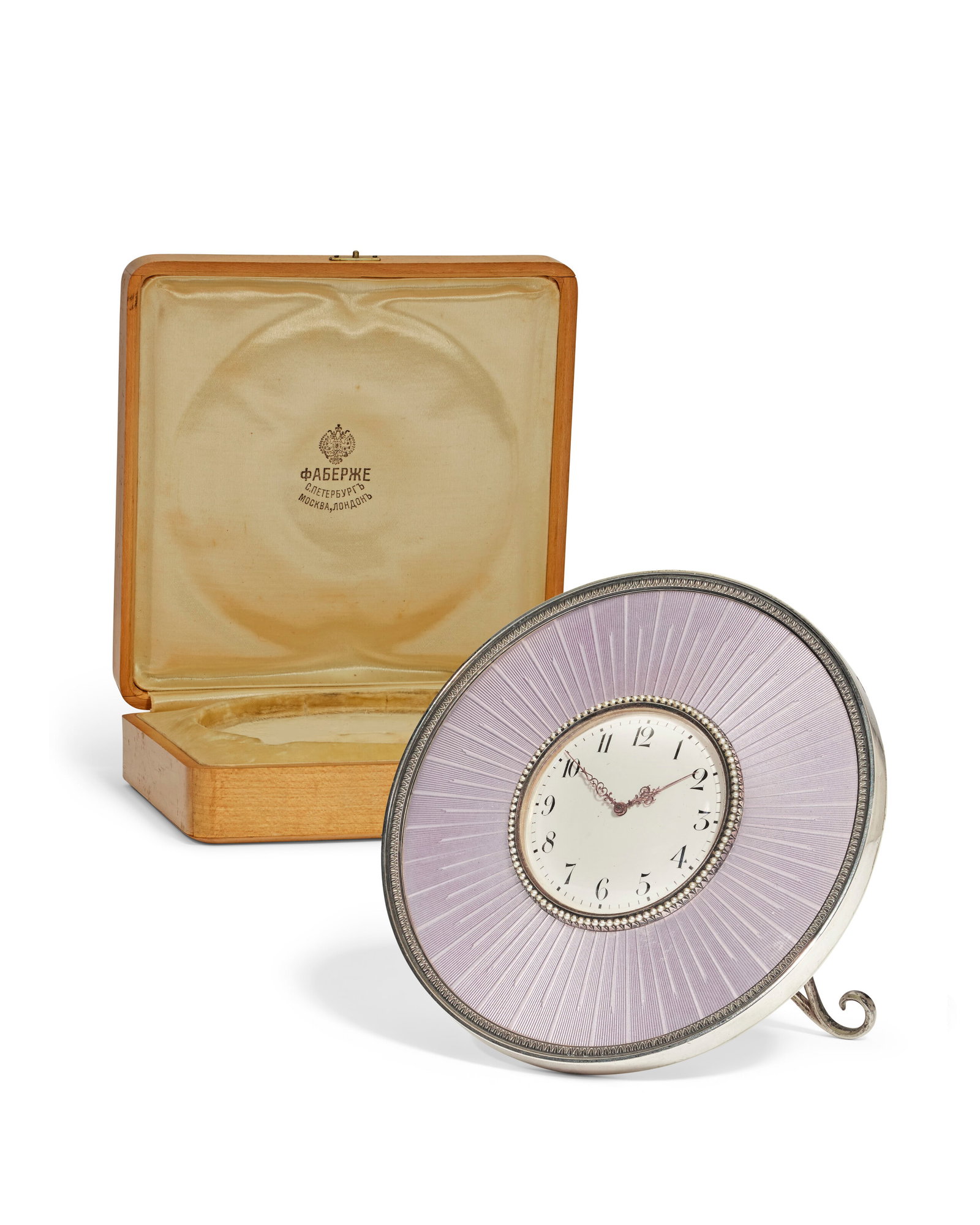 A GUILLOCHÉ ENAMEL SILVER DESK CLOCK BY FABERGÉ, WORKMASTER HENRIK WIGSTRÖM, ST.: Details A GUILLOCHÉ ENAMEL SILVER DESK CLOCK BY FABERGÉ, WORKMASTER HENRIK WIGSTRÖM, ST. PETERSBURG, CIRCA 1910, SCRATCHED INVENTORY NUMBER 19880 Circular, enameled in lilac over a sunb