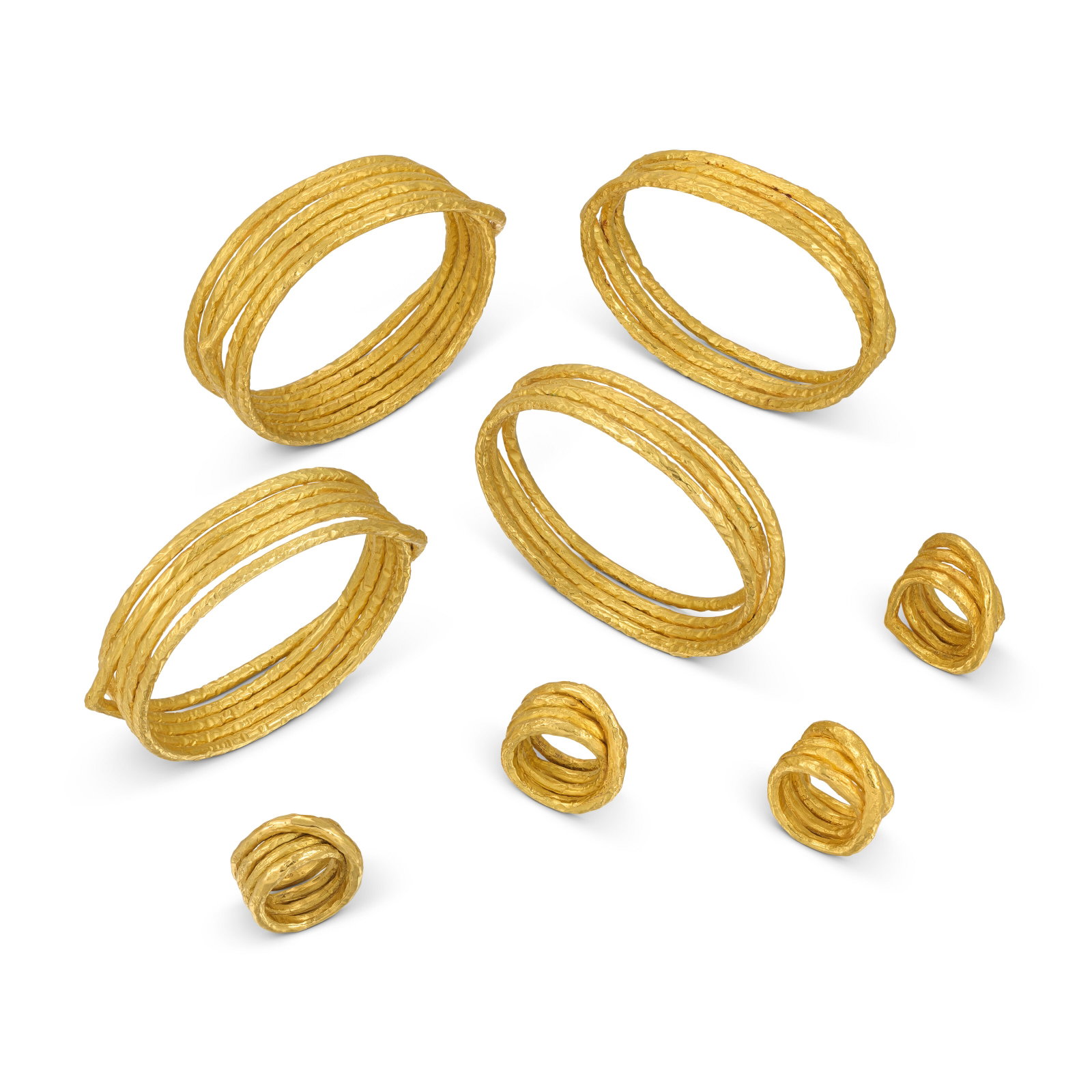 GROUP OF FOUR BANGLES AND FOUR RINGS: Details Of textured coiled design, bangles and two rings signed Krauss, two rings with maker's marks (Günter Krauss) Size/Dimensions: inner circumference 19.5 cm, inner diameter 6.5 cm, UK ring