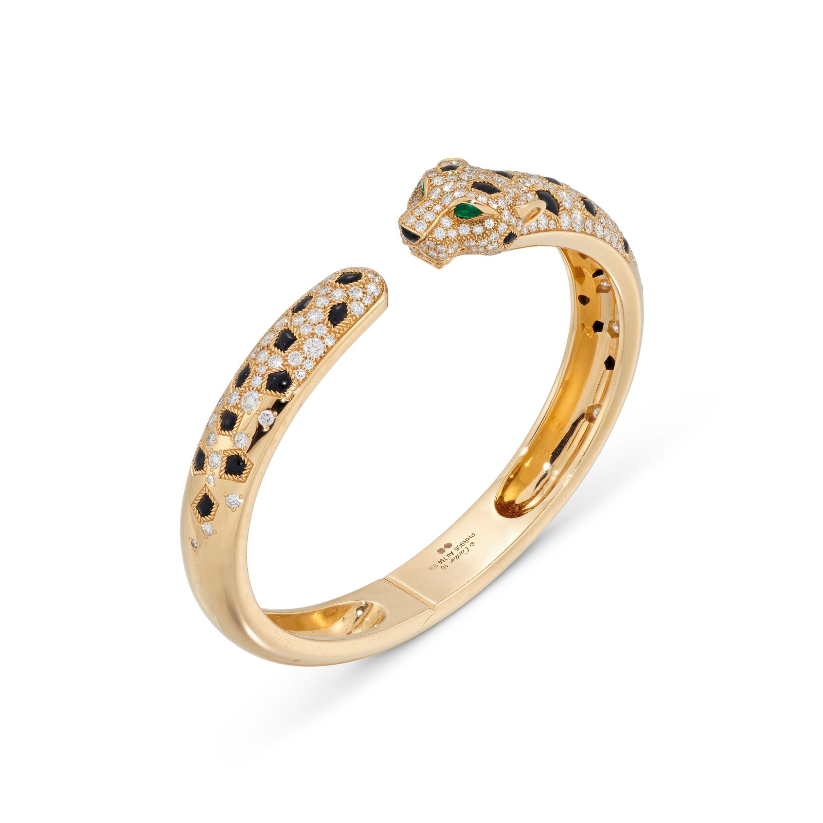 CARTIER GOLD, DIAMOND, ONYX AND EMERALD 'PANTHÈRE' BANGLE: Details Circular-cut diamonds, buff-top onyx cabochon spots, pear-shaped emerald eyes, gold (Swiss and European Convention marks), signed Cartier, maker's mark (PGI), numbered, red Cartier pouch Size/