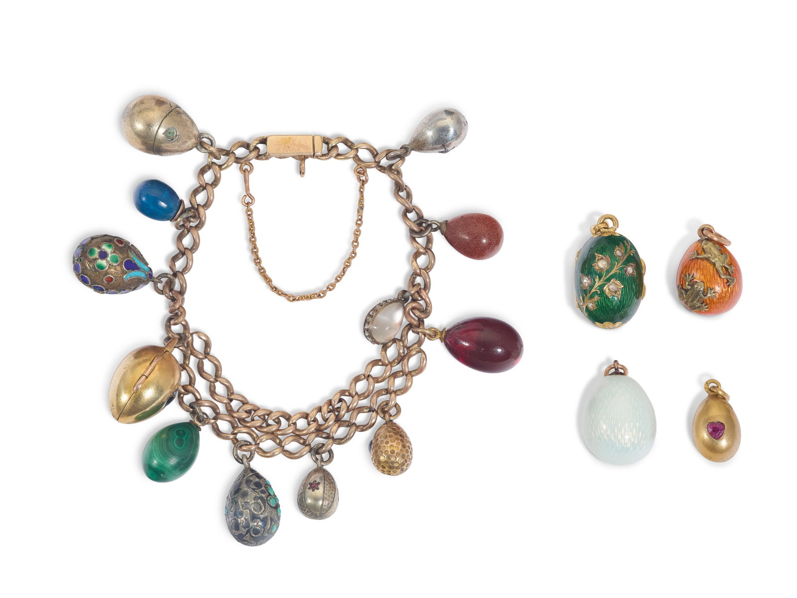 A GROUP OF FOUR JEWELED, ENAMEL AND GOLD EGG PENDANTS AND A BRACELET WITH TWELVE EGG PENDANTS (1 of 2)