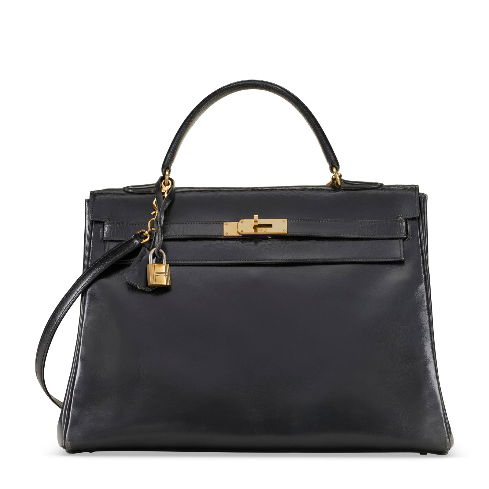 A BLACK CALF BOX LEATHER RETOURNÉ KELLY 35 WITH GOLD HARDWARE HERMÈS, 1959 (1 of 4)